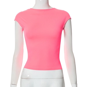 Detail of neon pink slim fit t-shirt featuring cap sleeves and a minimalist round neck