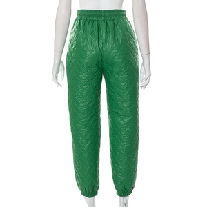 Detail view of green quilted jogger pants with elastic waist and back view on mannequin