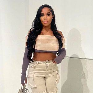Detail of off-shoulder knit crop top with long sleeves and thumbholes in beige and grey