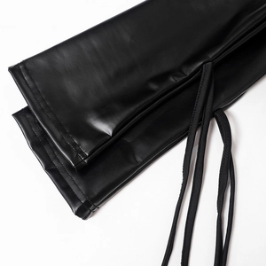Detailed close-up of black PU leather texture with stitching and drawstring accents