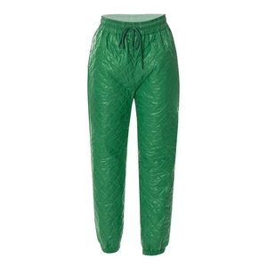 Close-up of bright green quilted jogger pants with elastic waistband and drawstring