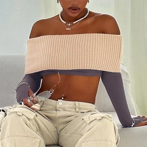 Detailed close-up of knit off-shoulder cropped top with contrast color ribbing and cargo pants
