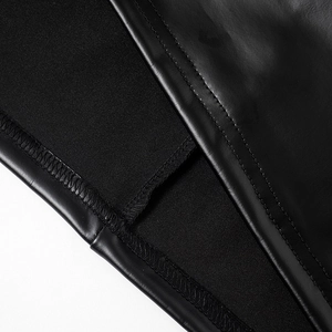 Detail of double stitching and mixed faux leather textures on this black strapless dress