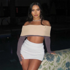 Detail of off-shoulder long sleeve crop top with ribbed trim and mini skirt