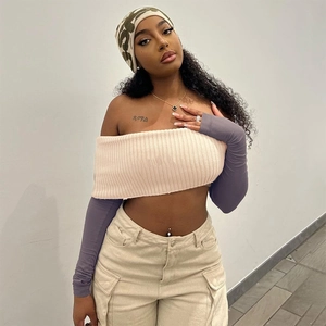 Detail of a color-block off-shoulder long sleeve crop top with stylish cargo pants