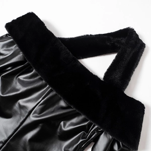 Detailed close-up of a black faux leather dress with plush fur trim and pleated texture