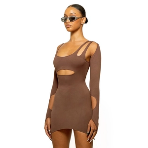 Detail of hollow-out geometric cutouts on deep brown bodycon dress with long sleeves