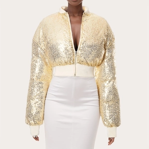 Close-up of golden sequin bomber jacket with white elastic ribbed cuffs and metal zipper