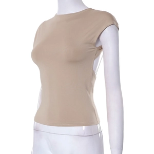 Side view of beige backless slim-fit top with thin transparent straps on a mannequin