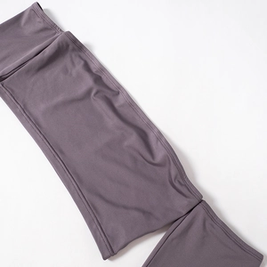 Detail of purple-gray knit top showing high-elastic fabric and flatlock stitching