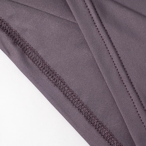 Detailed view of the fine knitting texture and high-quality flatlock seams on the purple top