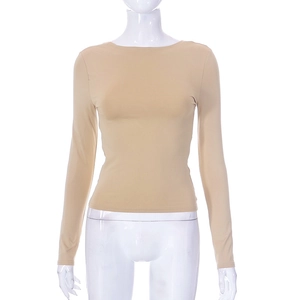 Dettaglio del top beige a maniche lunghe con vestibilità aderente e scollo rifinito