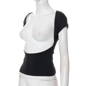 Detailed close-up of backless black crop top with a deep U-shaped cut and fitted waist design