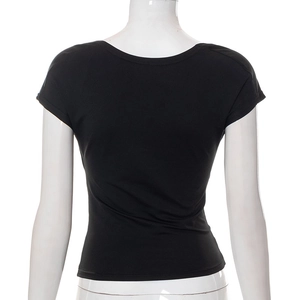 Detail of black slim-fit backless top with cutout design on a mannequin display