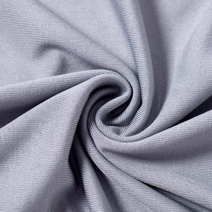Detailed macro texture of grey ribbed knit fabric with fine vertical patterns and elastic feel