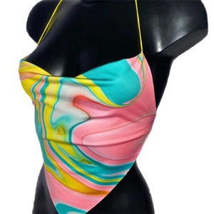 Detail of multi-color marble print halter top with thin yellow straps and draped neckline