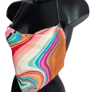 Detailed texture of silky halter top featuring vibrant marble print and triangular hemline