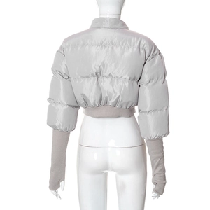 Detail view of silver cropped puffer jacket with long knit cuffs and thumbholes
