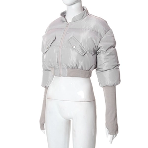 Detail view of silver quilted jacket with ribbed waist and thumbhole cuffs