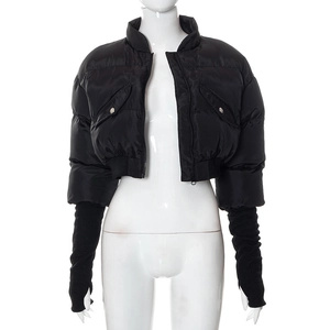 Detail of short black puffer jacket with long ribbed knit arm warmers and metal snap pocket