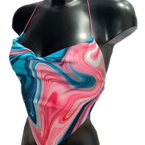Detail of pink and blue marble print halter crop top with satin finish on mannequin
