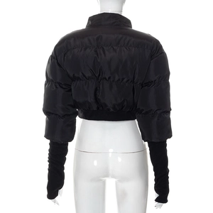 Detail of quilted jacket showing long ribbed knit cuffs with thumbhole on black fabric