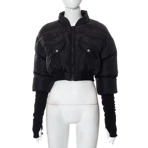 Detail of black cropped puffer jacket featuring thumbhole cuffs and a metal zipper