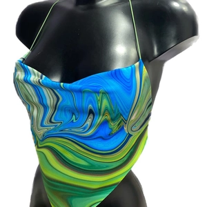 Detail of cowl neck and vibrant marble print on halter backless tie-up crop top