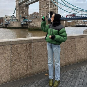 Women's color-block puffer jacket in green and black with zip front and slim fit