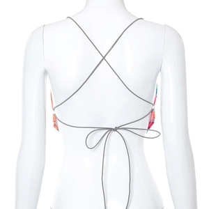 Detail view of the backless tie-up crisscross design and colorful print on the crop top
