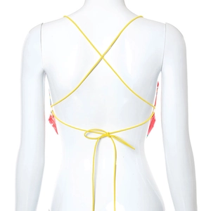 Detail of cross-back yellow tie straps and bowknot design on backless crop top