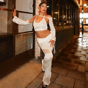 White knit 3-piece set featuring cutout halter top, shrug sleeves, and flared trousers