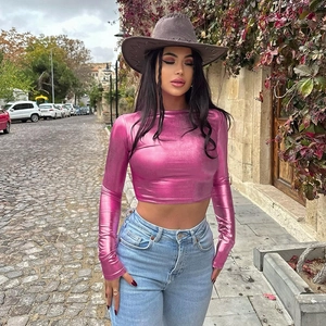 Detail of pink metallic long sleeve crop top showing shiny texture and slim fit design