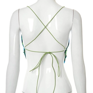Detailed back view of sleeveless halter top showing intricate green lace-up straps and abstract print