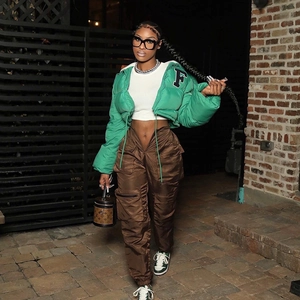 Women's green cropped puffer jacket with F patch paired with brown cargo pants