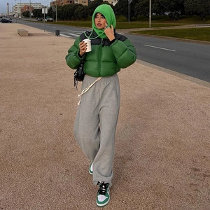 Close-up of vibrant green puffer jacket with zipper detail and sporty casual streetwear style