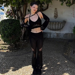 Detail of black crochet knit 3-piece set featuring cutout long sleeves and flared pants