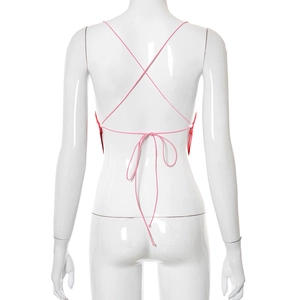 Detail view of pink butterfly top featuring backless cross-tie design and ribbon knots