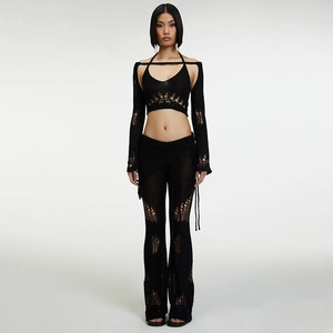 Detail of black hollow knit four-piece set showing texture and chic cutout patterns