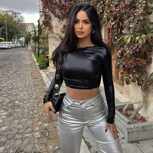 Slim fit black long sleeve crop top and metallic silver pants in an urban street setting