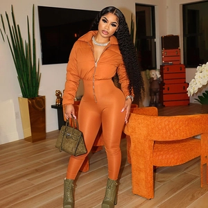 Detail of caramel orange quilted long sleeve jumpsuit with zipper and slim fit style
