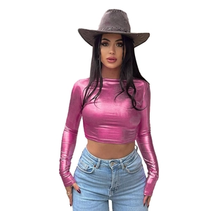 Detail of slim fit metallic pink crop top showing reflective fabric and long sleeves