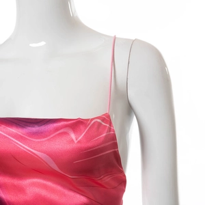 Detailed view of glossy satin slip top featuring abstract pink and purple wave patterns