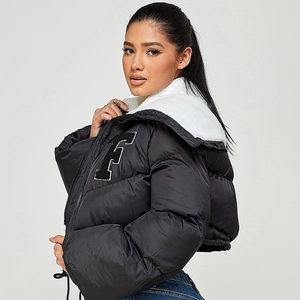 Detail of black quilted puffer jacket featuring white fleece collar and F embroidery