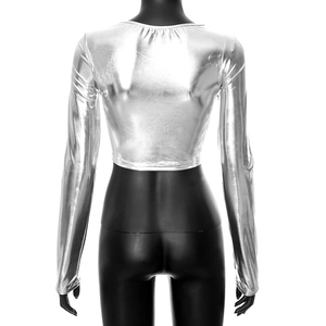 Macro view of silver metallic crop top fabric with reflective texture and slim fit design