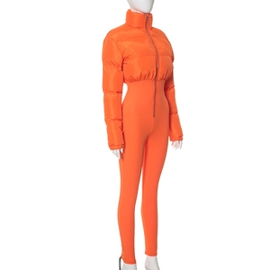 Close-up of quilted orange hooded jumpsuit with zipper and windproof high collar detail