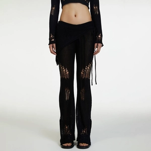 Close-up of black crochet knit spiderweb pattern on high-waisted pants and skirt overlay