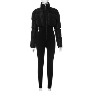 Close-up of black hooded puffer jumpsuit featuring horizontal quilting and silver zipper
