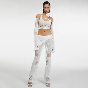 Detail view of a white crochet four-piece knit set including a halter top and flared pants