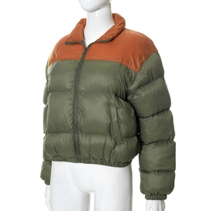 Detail of army green puffer jacket with contrasting orange shoulders and zipper